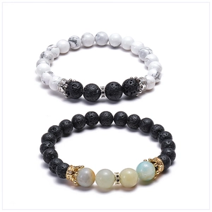 Close-up of crown beads on volcanic lava and turquoise stone stretch bracelets