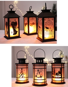 Detail of Christmas lantern with festive prints and warm LED flame effect