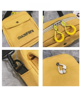 Detail view of yellow canvas crossbody bag featuring functional earphone hole and strap