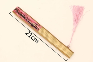 Detail of closed Japanese folding fan with pink fabric pattern and 21cm length marking