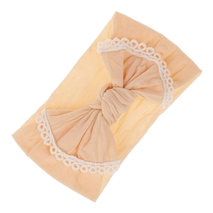 Soft nylon baby headband featuring a large bow with white lace trim in apricot color.
