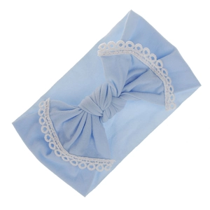 Close-up of soft light blue nylon baby headband with elegant white lace bow detail