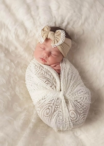 Detail of soft nylon lace headband and floral crochet wrap for newborn photography