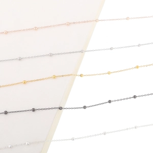 Minimalist beaded glasses chain in gold and silver finishes shown from a 45-degree angle