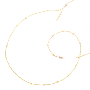 Detailed close-up of golden beaded metal chain for eyewear with clear silicone connectors