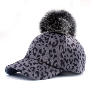 Grey leopard print baseball cap with a fluffy pom-pom detail on white background