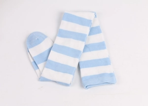Detail view of blue and white striped knee-high cotton socks in a clean flat lay style