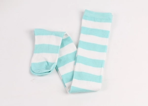 Flat lay detail of mint green and white striped over-knee socks on white background