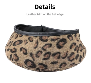 Close-up of leopard print beret featuring black leather trim and soft texture details