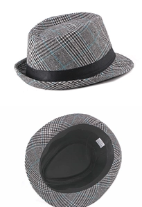 Detail view of houndstooth jazz fedora hat with size 58cm label and material tag