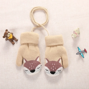 Detail of beige fox-themed knit mittens for kids featuring warm fleece lining and lanyard