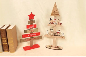 Close-up of DIY wooden Christmas tree decor with Santa motifs and festive lettering