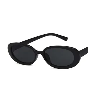 Classic black oval frame sunglasses with dark lenses in a minimalist retro style