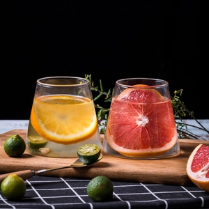 Creative Mount Fuji glass cups with colorful fruit drinks on a wooden tray with checkered cloth