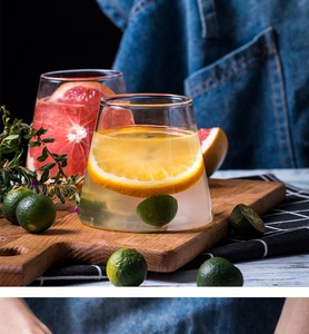 Detail of Mount Fuji shaped glass cups filled with fruit slices on a rustic wooden board