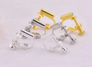 Close-up of adjustable gold and silver earring converters for non-pierced ears
