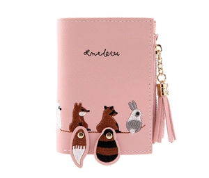 Pink PU leather wallet detail showing animal embroidery, tassel zipper and fuzzy tail charm