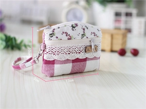 Close-up of a floral patchwork coin purse with dimensions 13x10x2cm and a lace detail