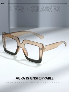 Close-up of dual-tone square glasses showing metal hinges and amber gradient frame