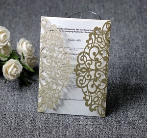 Detail of laser cut gold glitter 40th anniversary invitation with elegant floral hollow pattern