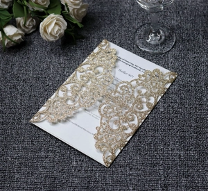 Detailed laser-cut hollow pattern on gold glitter paper invitation with floral accent