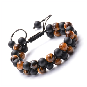 Detail of adjustable double-layer bracelet with tiger eye and matte black natural stone