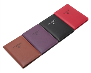 Travel passport holders in brown, purple, black, and red leather with RFID protection