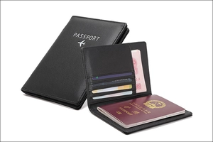 Detail view of black RFID leather passport holder with slots for cards and cash