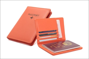 Detail view of orange RFID passport wallet with multiple card slots and leather texture