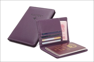 Detail view of purple leather RFID passport wallet with multiple card slots and passport pockets