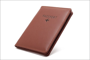 Close-up of brown faux leather passport holder with RFID protection and Passport text