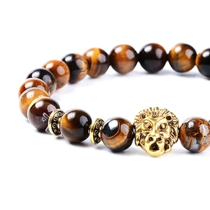 Brown tiger eye stone bead bracelet with a golden lion head and spacer accents