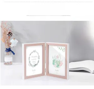 Detail of a 5x7 inch white and wood foldable frame with metal hinges in Nordic style