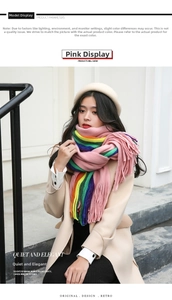 Close-up of pink knit scarf with rainbow stripes and elegant long fringe detail