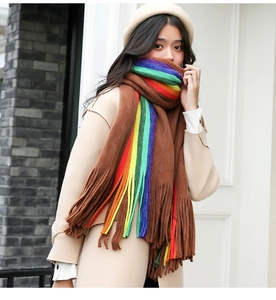Detail of winter rainbow scarf with long tassels and thick cashmere-like texture