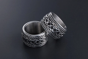 Macro view of vintage woven pattern on titanium steel ring with silver and black finish