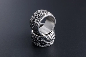 Macro view of vintage titanium steel rings featuring intricate Celtic knots and woven texture