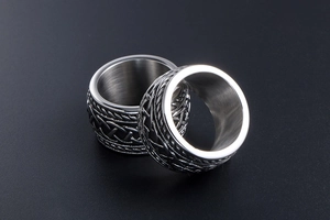Macro shot of silver stainless steel rings with intricate Celtic woven patterns