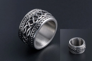 Macro shot of silver titanium steel ring with vintage Celtic knot pattern and brushed finish