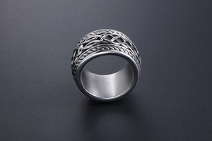 Close-up of vintage punk steel ring featuring intricate Celtic knot textures and industrial style