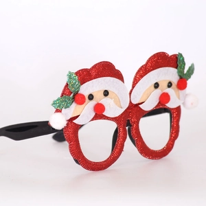 Detail of red glitter Christmas glasses frame featuring a plush Santa Claus felt topper
