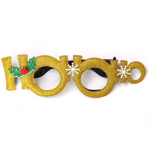 Detail of Ho Ho Ho Christmas glasses with gold glitter, holly leaves and snowflake decor