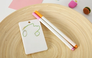 Macro shot showing DIY hand-painted design on a white ABS plastic card holder with markers