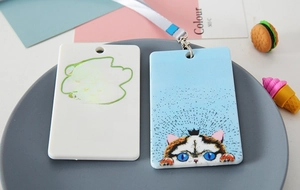 Detail view of DIY white and blue cat-patterned ABS plastic ID card holders with lanyards