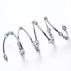 Silver wrap bracelet with iridescent square crystals and turquoise beads on white background