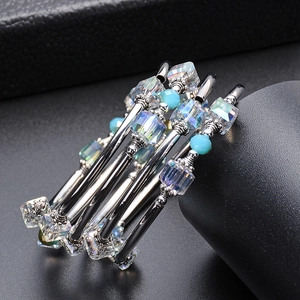Macro shot of multi-layer wrap bracelet featuring light blue beads and square crystals