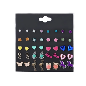 Detailed view of 20 pairs of fashion gold alloy studs with anchors and unicorns on card