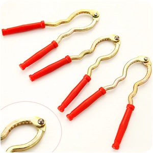 Heavy duty metal nutcracker with red handle grips and close-up detail of serrated jaws