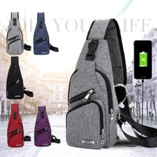 Detail of grey oxford sling bag featuring external USB charging port with phone connection