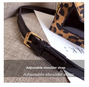 Detail of adjustable shoulder strap with gold buckle on leopard print crossbody bag